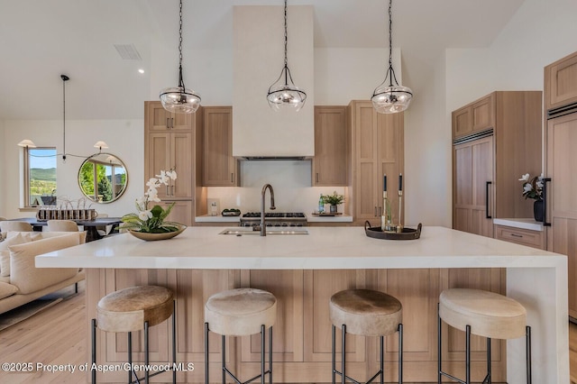 112 Bowles Dr, Carbondale, CO 81623 - kitchen with a sink, paneled built in fridge, light countertops, a kitchen bar, and high vaulted ceiling