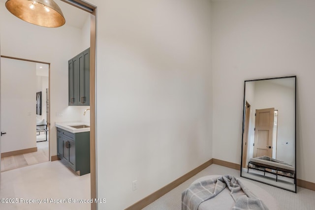 112 Bowles Dr, Carbondale, CO 81623 - bedroom featuring a sink, a towering ceiling, and baseboards