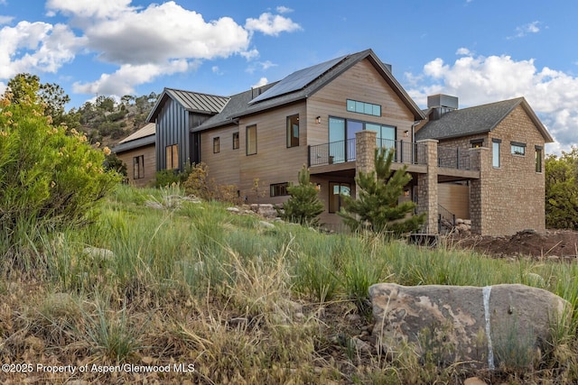 112 Bowles Dr, Carbondale, CO 81623 - view of front facade featuring solar panels, board and batten siding, and a balcony