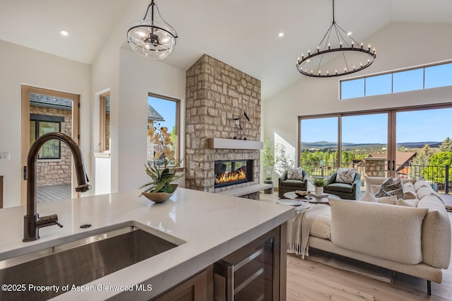 112 Bowles Dr, Carbondale, CO 81623 - kitchen featuring a chandelier, open floor plan, a sink, high vaulted ceiling, and recessed lighting