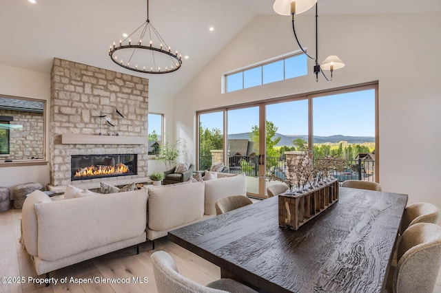 112 Bowles Dr, Carbondale, CO 81623 - dining space with a chandelier, high vaulted ceiling, wood finished floors, recessed lighting, and a fireplace