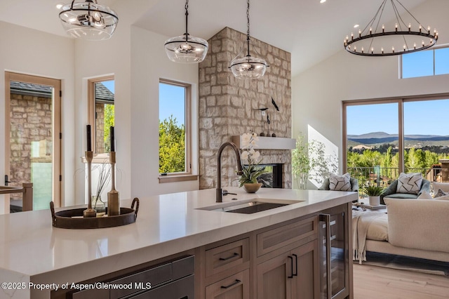 112 Bowles Dr, Carbondale, CO 81623 - kitchen featuring a sink, open floor plan, beverage cooler, high vaulted ceiling, and a chandelier