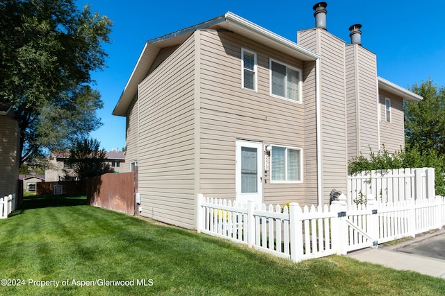 view of side of home featuring a yard