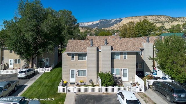 view of front facade with a mountain view and a front yard