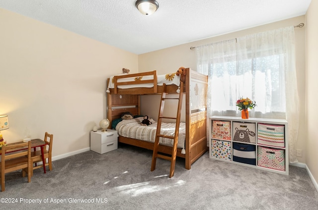 carpeted bedroom featuring a textured ceiling