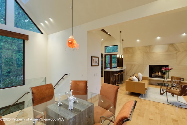 71 Smuggler Grv, Aspen, CO 81611 - dining space featuring high vaulted ceiling, light wood finished floors, and a premium fireplace