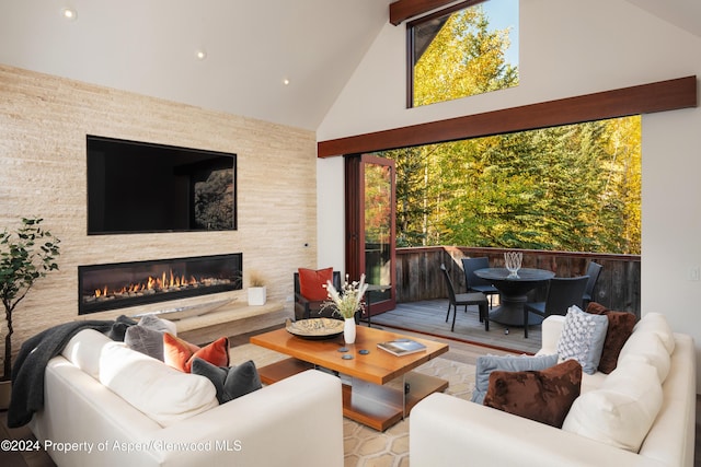 71 Smuggler Grv, Aspen, CO 81611 - living area with high vaulted ceiling, a large fireplace, recessed lighting, and wood finished floors
