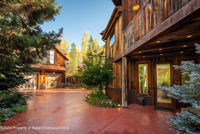 71 Smuggler Grv, Aspen, CO 81611 - view of side of property with a garage, concrete driveway, and a patio