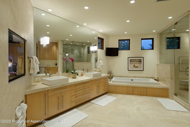 71 Smuggler Grv, Aspen, CO 81611 - bathroom with a shower stall, recessed lighting, double vanity, a garden tub, and tile patterned flooring