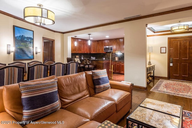 living room featuring ornamental molding and dark wood-type flooring