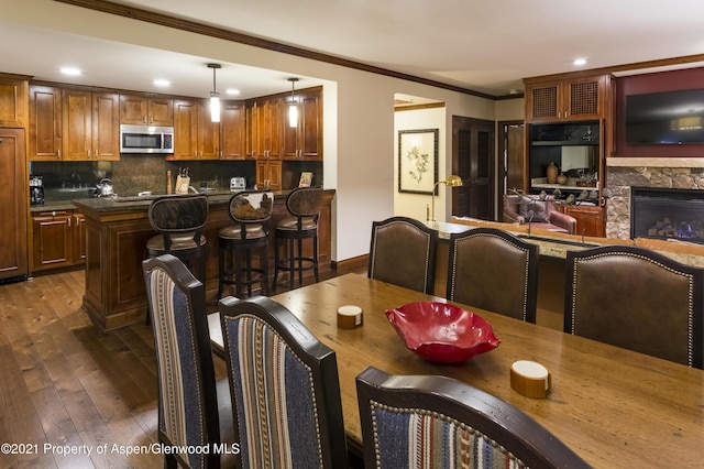 0197 Prospector Rd Unit 2412Summer Interest, Aspen, CO 81611 - dining area with dark wood-style floors, recessed lighting, a fireplace, and crown molding