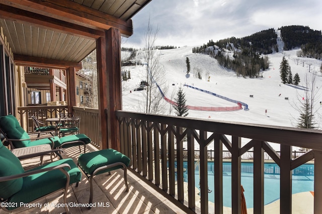 0197 Prospector Rd Unit 2412Summer Interest, Aspen, CO 81611 - snow covered back of property with a mountain view and view of pool area