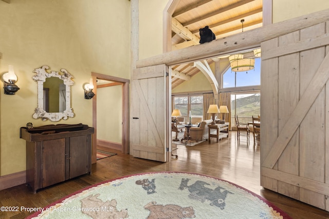 800 Chateau Way, Snowmass, CO 81654 - bedroom featuring a barn door, dark hardwood / wood-style flooring, and high vaulted ceiling