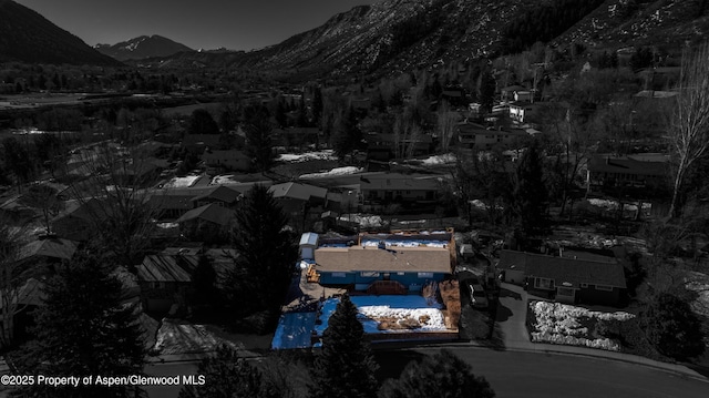 snowy aerial view with a mountain view