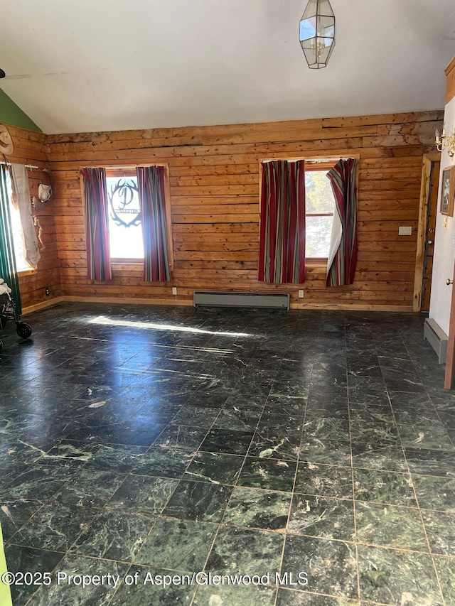 foyer featuring lofted ceiling, baseboard heating, and wood walls