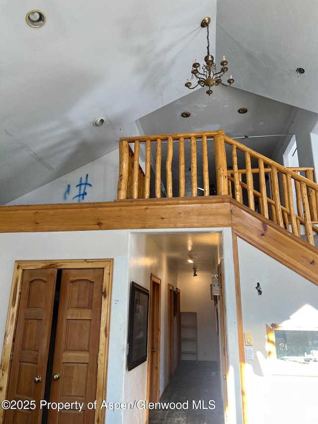 stairs featuring high vaulted ceiling