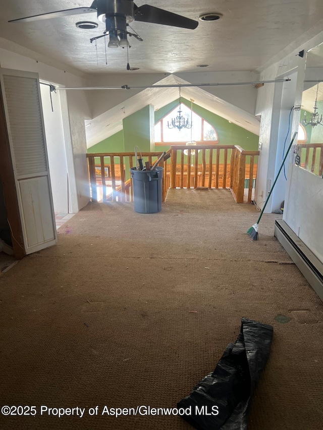 recreation room featuring lofted ceiling, an inviting chandelier, a healthy amount of sunlight, and carpet