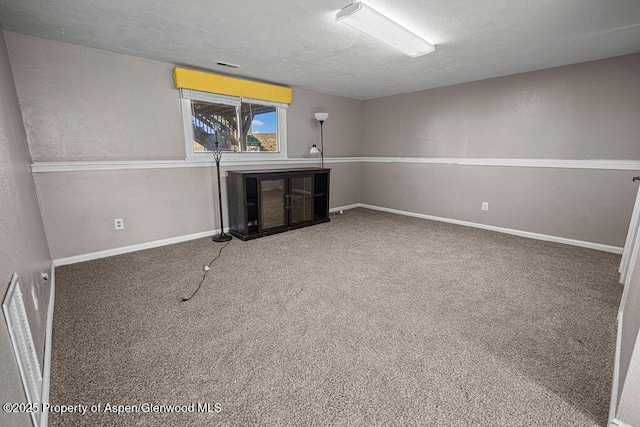 830 Exmoor Rd, Craig, CO 81625 - basement featuring a textured ceiling and carpet flooring