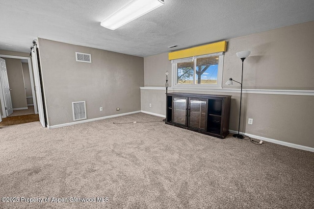 830 Exmoor Rd, Craig, CO 81625 - unfurnished living room with a textured ceiling and carpet floors