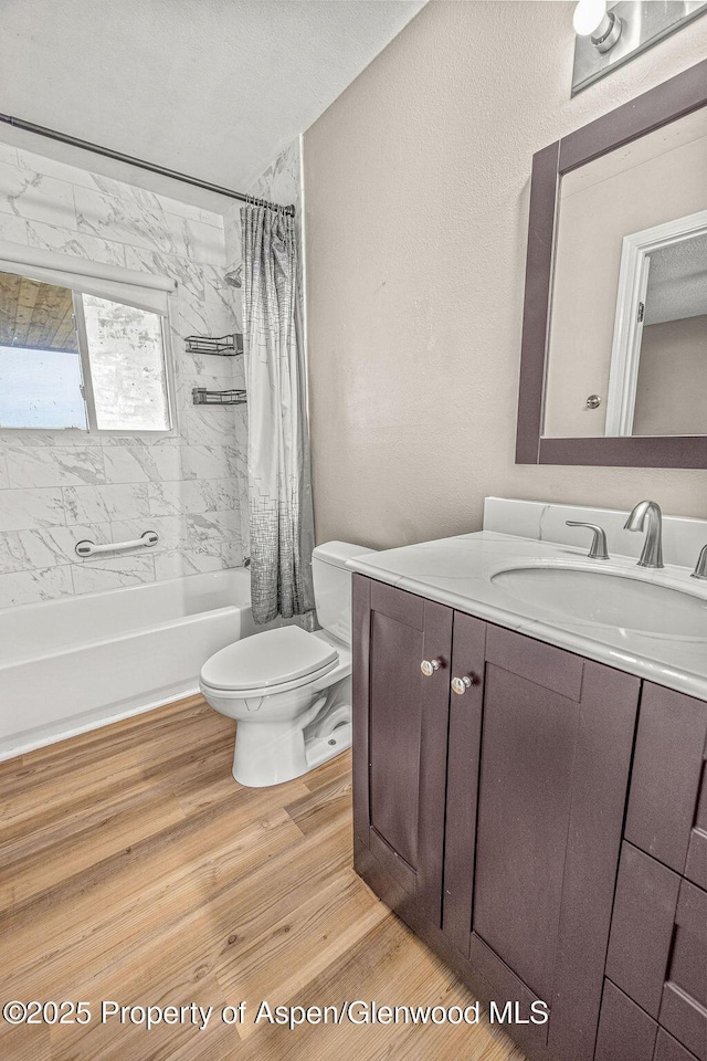 830 Exmoor Rd, Craig, CO 81625 - bathroom with vanity, toilet, shower / bathtub combination with curtain, and wood finished floors