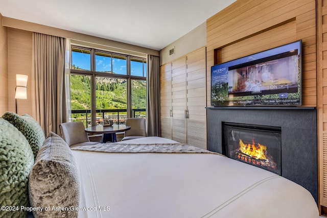 bedroom with wood walls