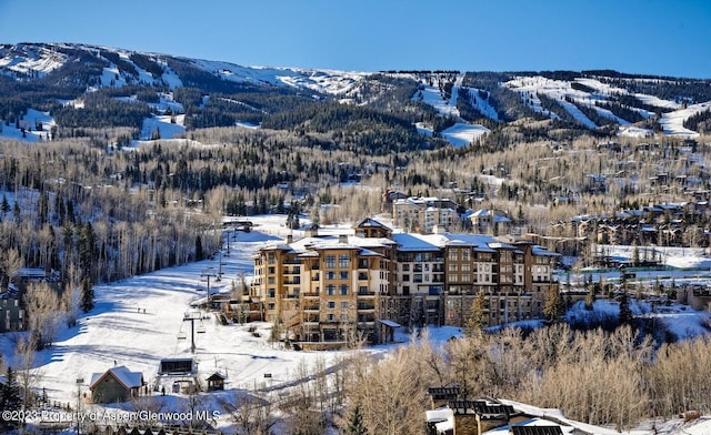 snowy aerial view featuring a mountain view