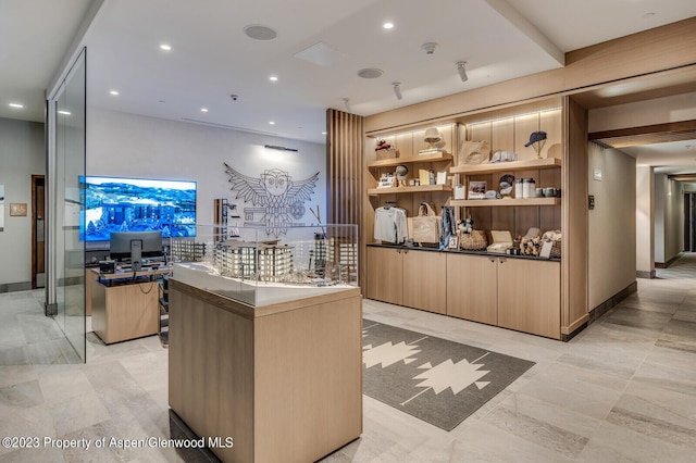 bar featuring light brown cabinetry