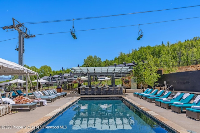 view of swimming pool featuring a pergola and a patio