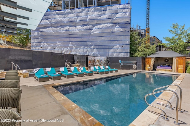 view of swimming pool with a patio area