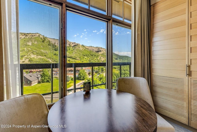 sunroom / solarium featuring a mountain view and a healthy amount of sunlight