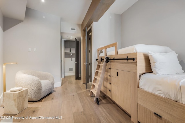 bedroom featuring light wood-style flooring and baseboards