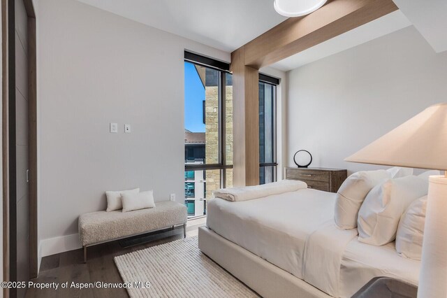 bedroom with wood finished floors and baseboards