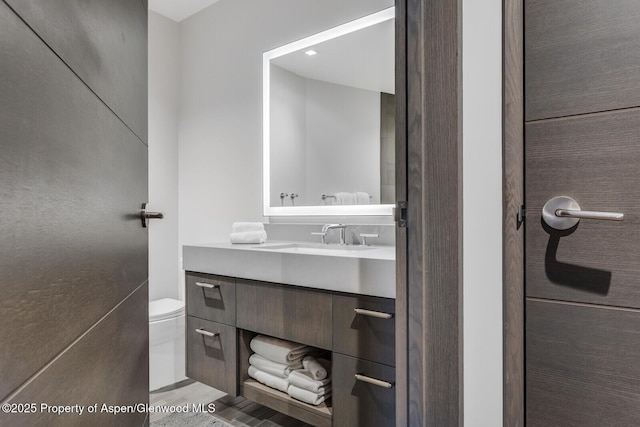 bathroom with toilet and vanity