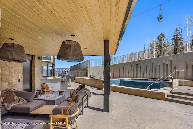 view of patio featuring a fenced in pool, a fire pit, and fence