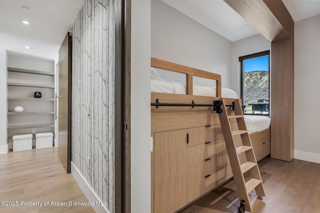 hall with wood finished floors and baseboards