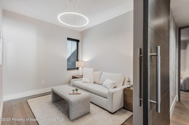 living room featuring light wood finished floors and baseboards