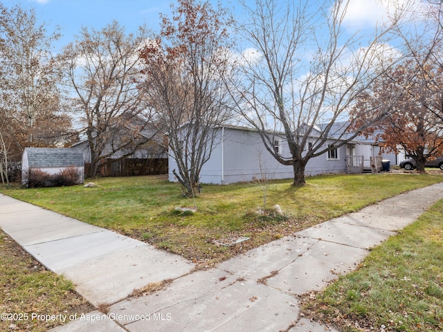 exterior space featuring a yard and a shed