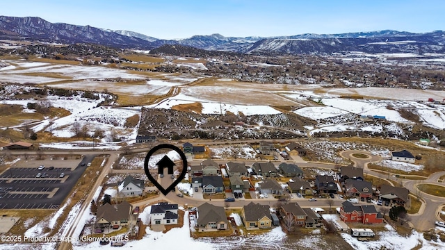 snowy aerial view with a mountain view