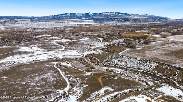 snowy aerial view with a mountain view