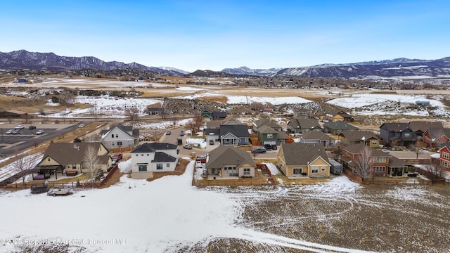 snowy aerial view with a mountain view