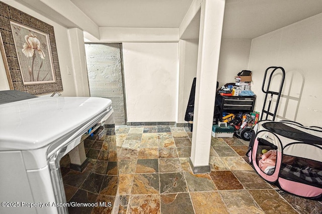 949 Breeze St, Craig, CO 81625 - full bath featuring stone tile flooring, washer / clothes dryer, and an enclosed shower