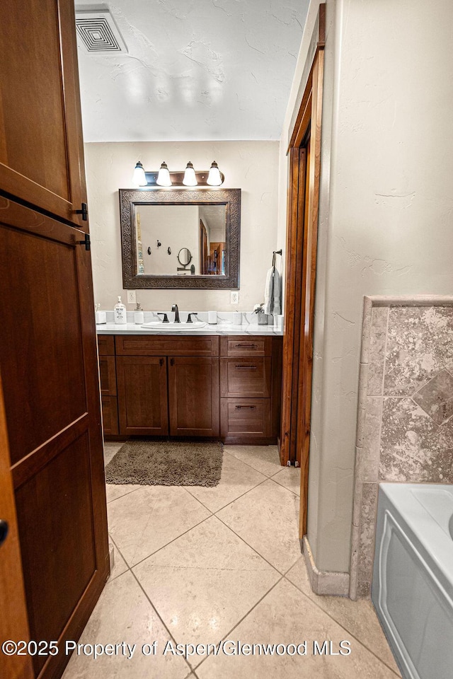949 Breeze St, Craig, CO 81625 - bathroom with vanity, a garden tub, and tile patterned flooring