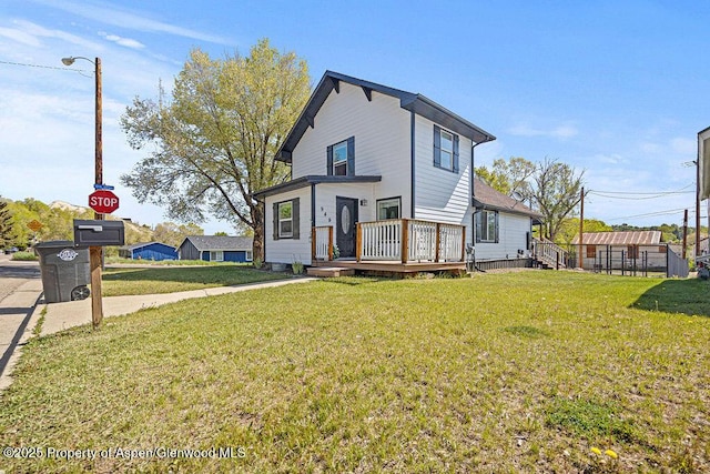 949 Breeze St, Craig, CO 81625 - view of front of property featuring a deck and a front lawn