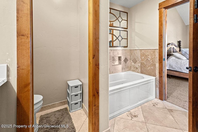 949 Breeze St, Craig, CO 81625 - full bath featuring a bath, tile patterned flooring, toilet, and ensuite bath