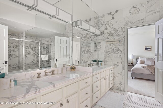 bathroom with a shower with door and vanity