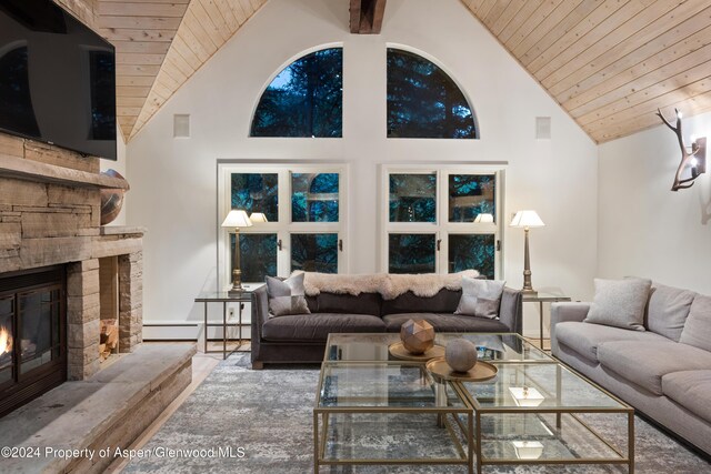 living room featuring a fireplace, a baseboard heating unit, high vaulted ceiling, and wooden ceiling