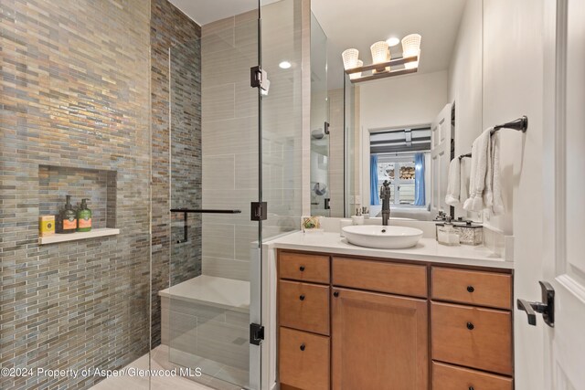 bathroom with tile patterned flooring, vanity, and an enclosed shower