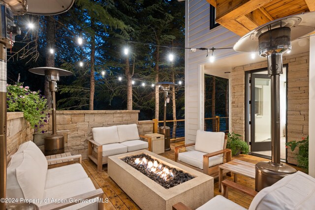 view of patio with an outdoor living space with a fire pit