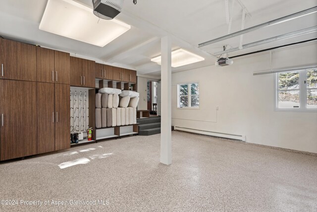 garage featuring baseboard heating and a garage door opener