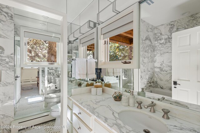 bathroom featuring vanity, toilet, and a tub to relax in